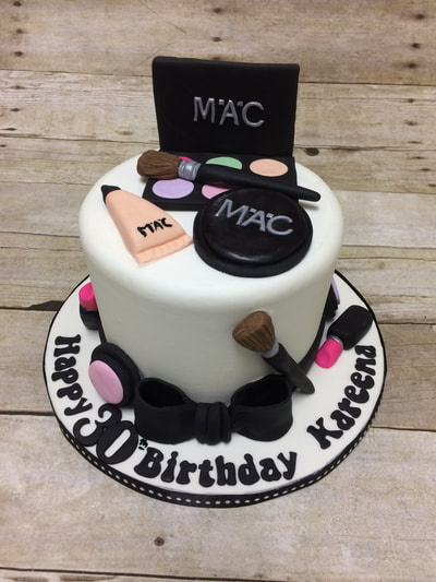 make up and cosmetics happy birthday cake. single tier fondant and chocolate made to look like cosmetics and brushes