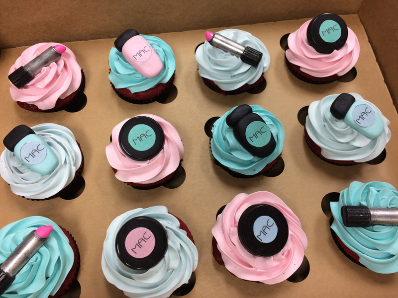 Sweet 16 custom cupcakes in pink and blue. topped with fondant accents of lipstick, makeup compacts.